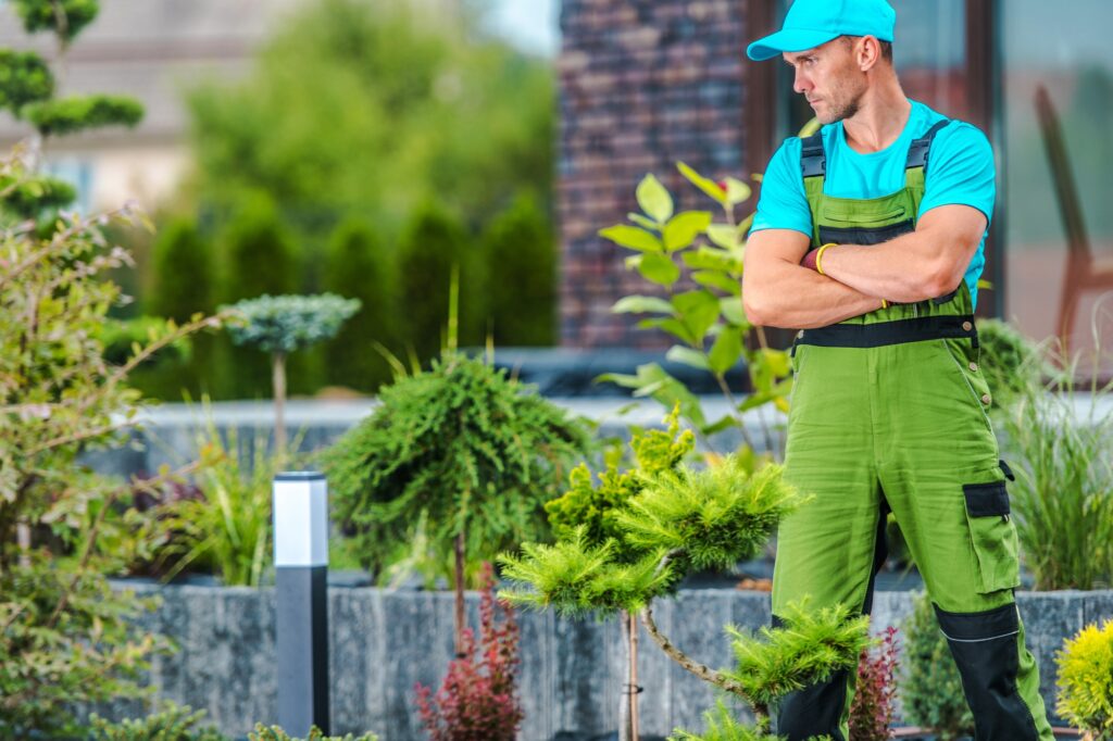 Professional Landscaper Proudly Standing in the Garden