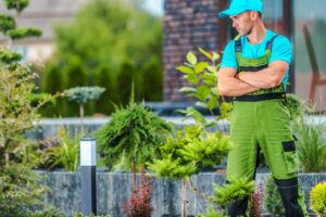 Professional Landscaper Proudly Standing in the Garden